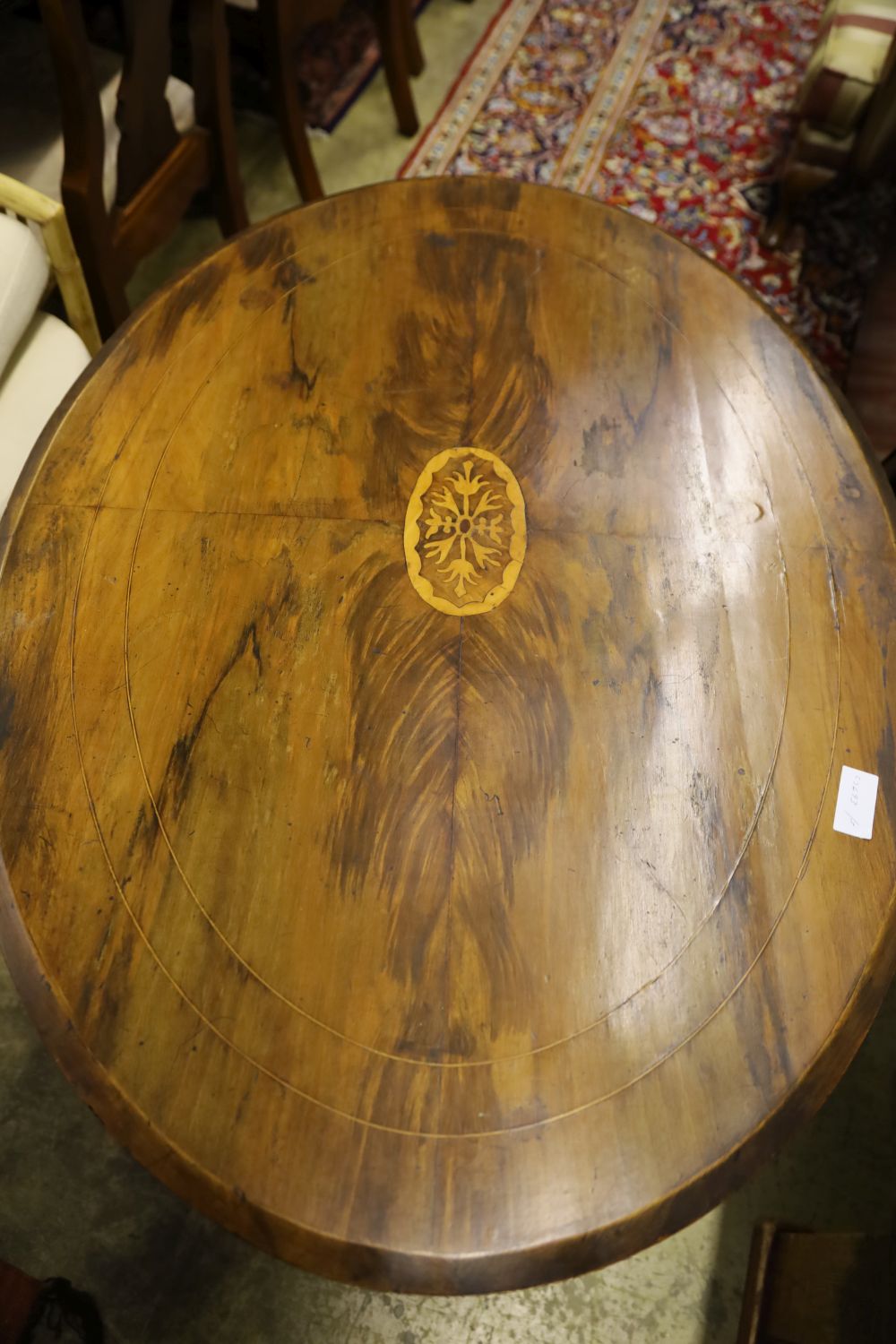 A Victorian inlaid walnut oval topped tea table, width 104cm, depth 72cm, height 71cm, no bolts